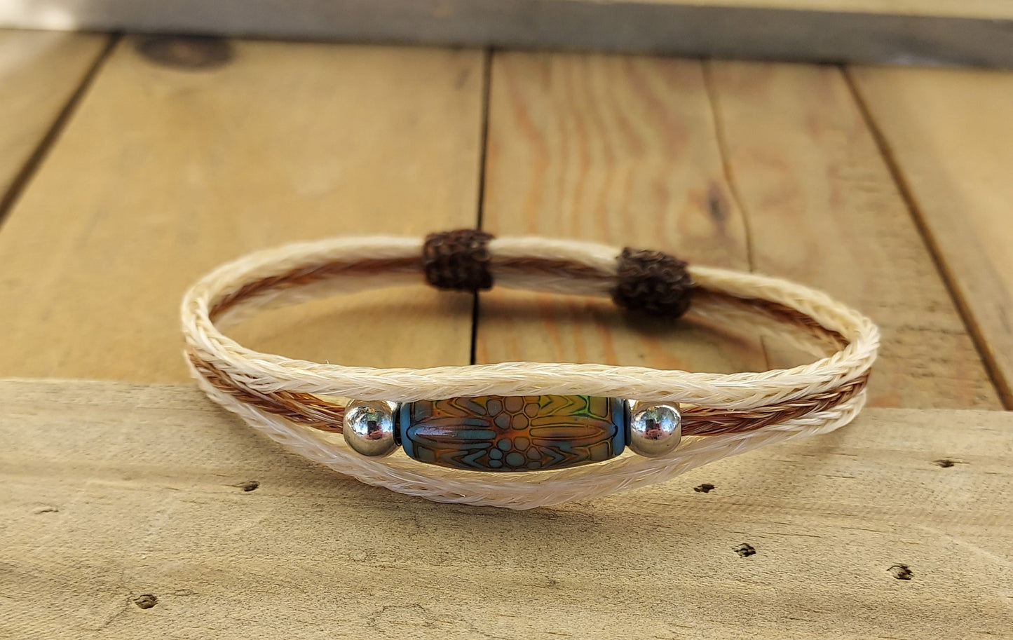 Bracelet with a bead on a wooden surface