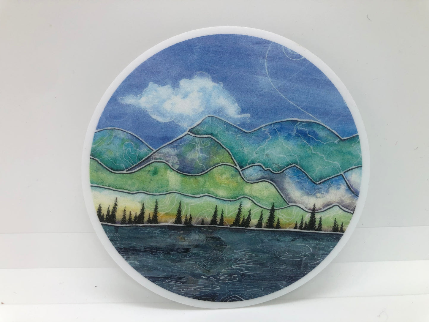" Cottonwood Peak " Sticker Artist: Nancy Marlatt Made from Nancy Marlatt's original artwork 3" round sticker is a high quality custom vinyl sticker that has uv laminate on top Which means they are outdoor friendly and protected for wind, rain and sunlight They are even dishwasher safe Matt Finish Great to send to friends and family Enjoy on your laptop, water bottle and more!