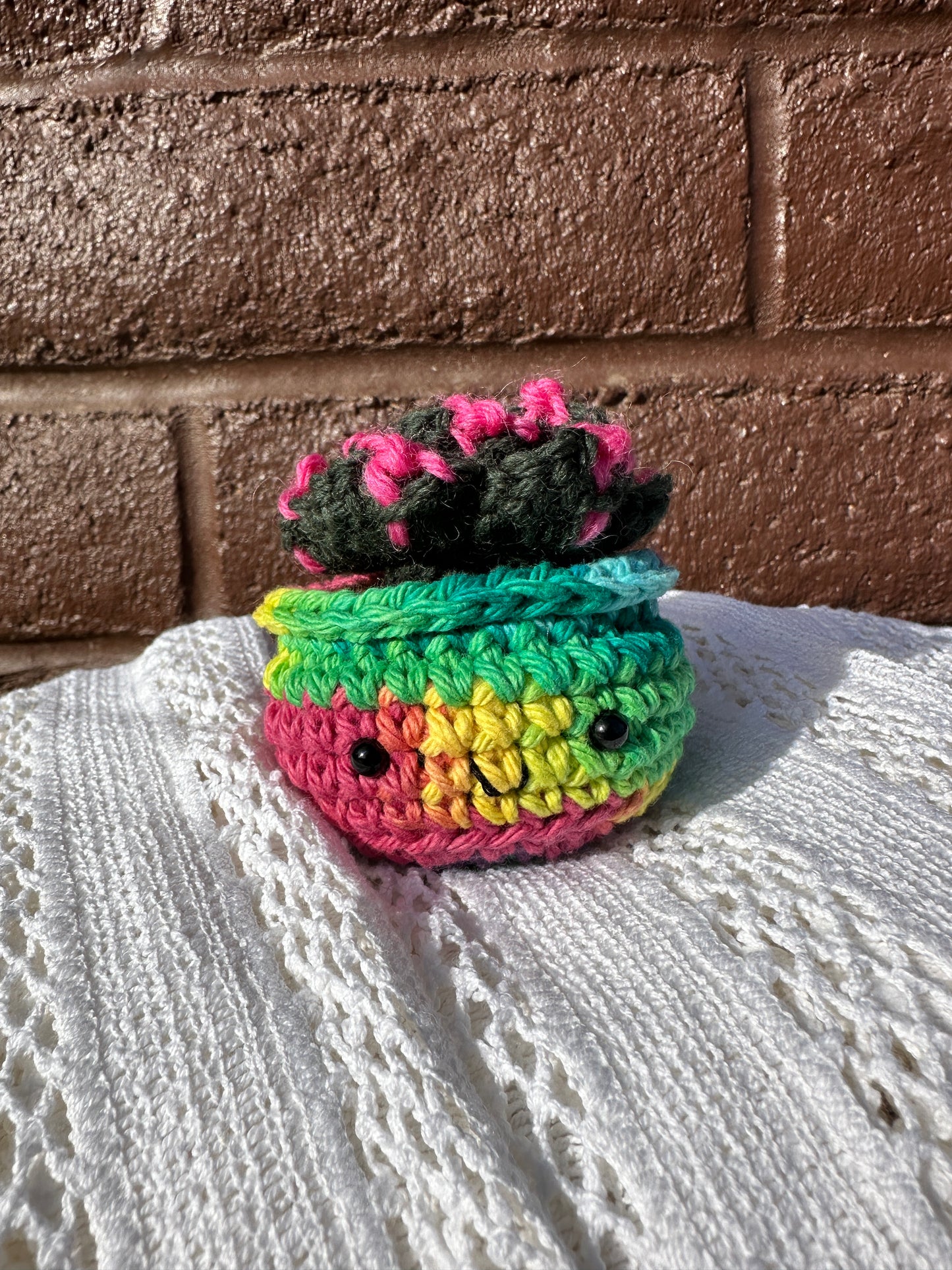 Crochet Cactus ;Succulent in Rainbow Pot with Forest Color
Artist: Claire Pearson
These crochet succulents are the perfect squishy companion for any cacti enthusiast
No light or sun requirements necessary- simply squish, place, and enjoy
All cactus are meticulously handmade with a combination of wool and cotton fibers
The faces of these cacti feature safety eyes which may present a choking hazard in small children, supervision advised
2" tall x 2 1/2" wide x 2"