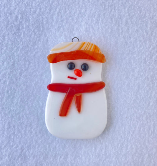 Snowman wearing an Orange hat with dark orange stripe  Hat is a mix of white and orange stripes  Fused Glass Ornament  2" long x 3" high x 1/4" wide fused glass 