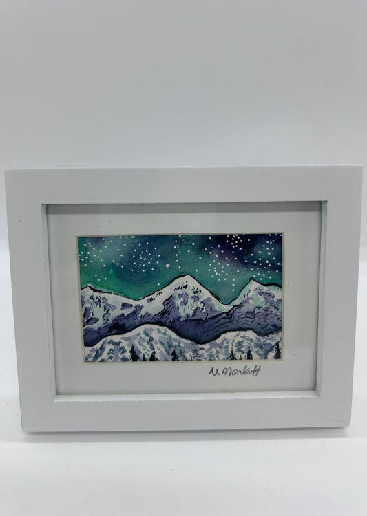 Original miniature watercolor  Snow capped Teton Mountains with a starry sky overhead  Aurora adds color to the night sky  Framed in a white wooden frame  Easel back allows to display on a table or shelf   4.75" long x 3.75" high