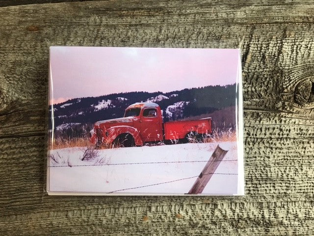 Old Red Truck Greeting Card Four Pack Photographer: Lisa Edwards Old red truck against a dark blue mountain surrounded by snow in a field Four pack of cards with envelopes Nice for greeting cards for all Blank card Envelope included 4" wide x 5.5" long