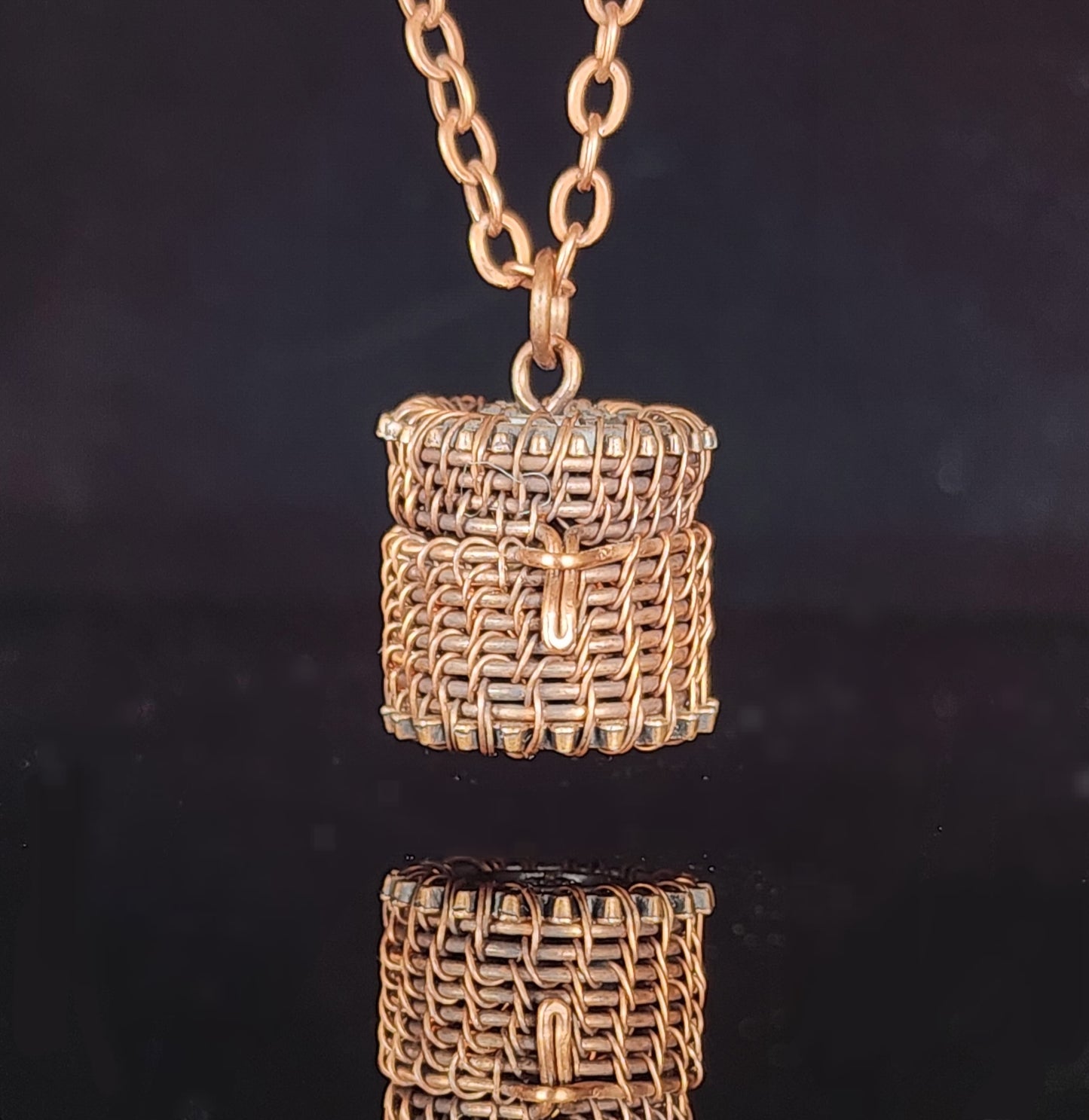 Hand woven oxidized copper wire Small basket pendant that can be used with an essential oil bead (bead not provided) .8" long x .7" wide Copper chain necklace with lobster clasp Care instructions and cleaning cloth provided