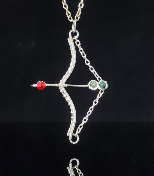 Bow and Arrow Pendant with Agate  Artist: Lindsey Griffin    Indian Agate and Swarovski beads in silver colored artistic wire   Silver pleated snake chain 16" long   2 1/4" long x 1 1/2" wide 1/16" deep pendant  Comes with care instructions and cleaning cloth  Beautiful necklace  Perfect for the enthusiast in your family  A great conversation piece!