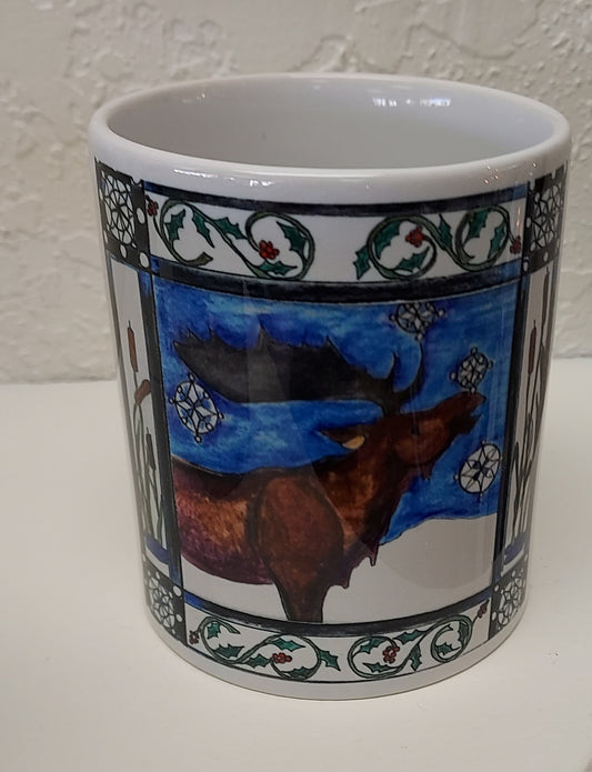 " Moose and Snow " Mug Artist: Celeste Havener 8 oz white ceramic mug with handle  Print of the original drawing " Moose and Snow " is on the mug  Moose with snowflakes surrounded by cattails and other holiday greenery  Great for a cup of coffee or tea