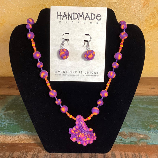 Variety Mixed Colors Polymer Clay Necklace and Earring Set Artist: Glenda Haley  Original, handcrafted Necklaces with matching Earrings  Created from Polymer Clay in Yellow, Orange and Purple swirls  The Earrings are drop beads from matching clay  Polymer Can Techniques  Beads are hand made  Glass accent beads. Purples and yellow
