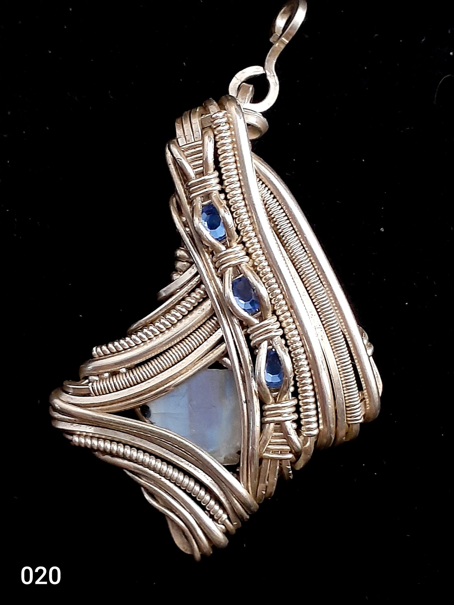 Abstract Raw Moonstone Necklace Artist: Lindsey Griffin Wired Wrapped Abstract Raw Moonstone with Swarovski Blue Crystals 2 5/16" long x 1 3/8" wide Silver Wire