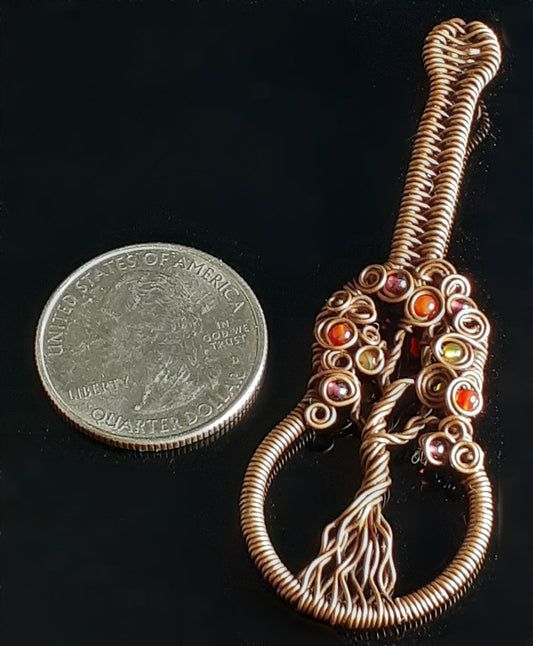 Autumn Colored Tree Of Life Guitar Pendent Artist: Lindsey Griffin Agate beads in Autumn colors wrapped in oxidized copper Guitar shaped with wrapped wire and agate beads. Leather cord to wear as a necklace 2 7/8" Long x 1" Wide x 1/4" Deep Care instructions and polishing cloth included A beautiful delicate necklace for everyday use