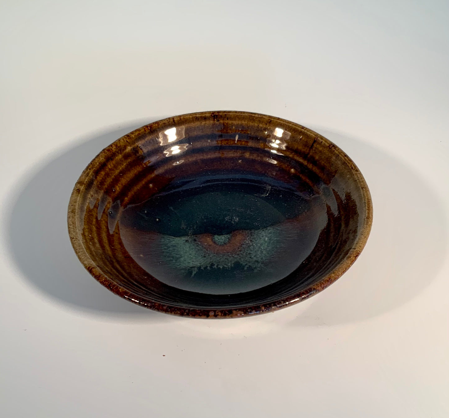 Green Glaze Ceramic Low Bowl Muffy Moore: Ceramic Potter Green glaze brown color low bowl 7" Long x 7" Wide x 2" High Ceramic with a high fire make it dishwasher, oven and food safe Great fruits and vegetables bowl Please note Items are handmade by Artist and a slight variation from piece to piece