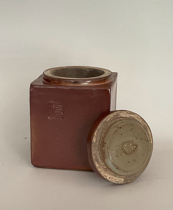 Shino Glaze Lidded Jar With Stamp Muffy Moore: Ceramic Potter Hand thrown stoneware Jar with lid Shino glaze Stamp on one side of the jar " Happiness " Large opening with hedgehog stamp on underside of the lid Dishwasher safe, oven and food safe 4" long x 4" wide x 4.5" tall