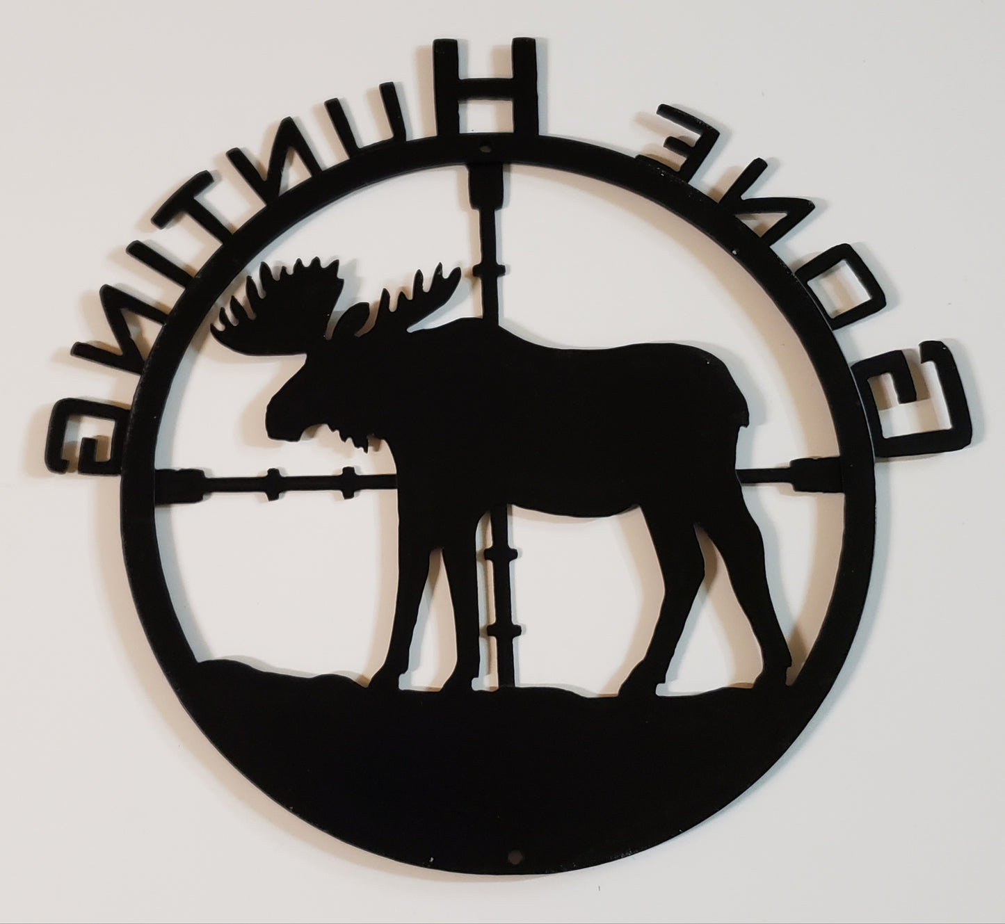 Back of the metal sign shows hole placement for hanging at top and bottom