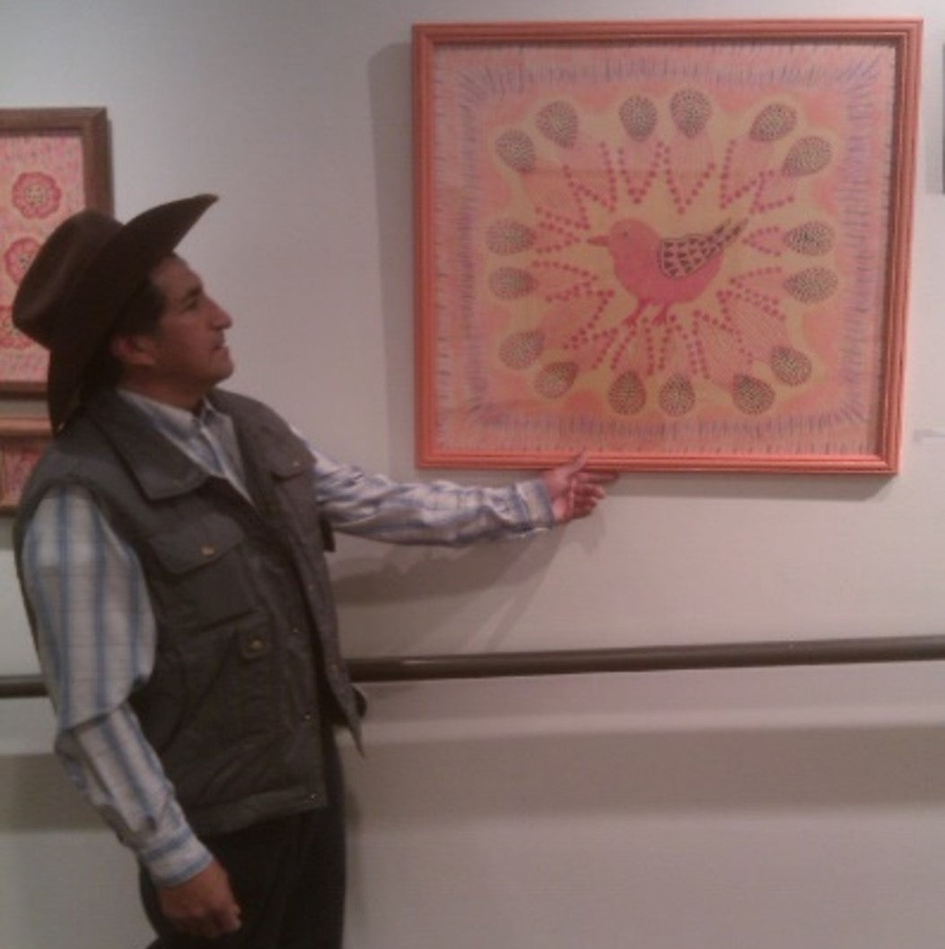 Alberto Alcantara, Purvian Folk Artists, shows his original fiber art.