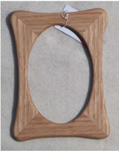 Magnetic Rectangular frame with oval opening  Red Oak  Beautifully handcrafted wooden frame with magnet  5" long x 6 1/2" high x 3/10" wide  Magnet inside the frame allows frame to hang on any metal surface
