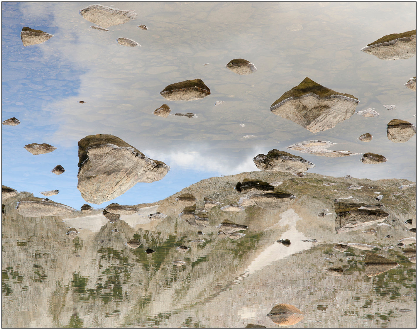 " Rocks in Reflection " Photography Print  Artist: Rick Walters  Rocks in a mountain lake   Snowy Range Mountain can be seen in the reflection  10" long x 8" wide  Printed on classic photo paper using archival pigment ink  In plastic sleeve and on foam board for protection