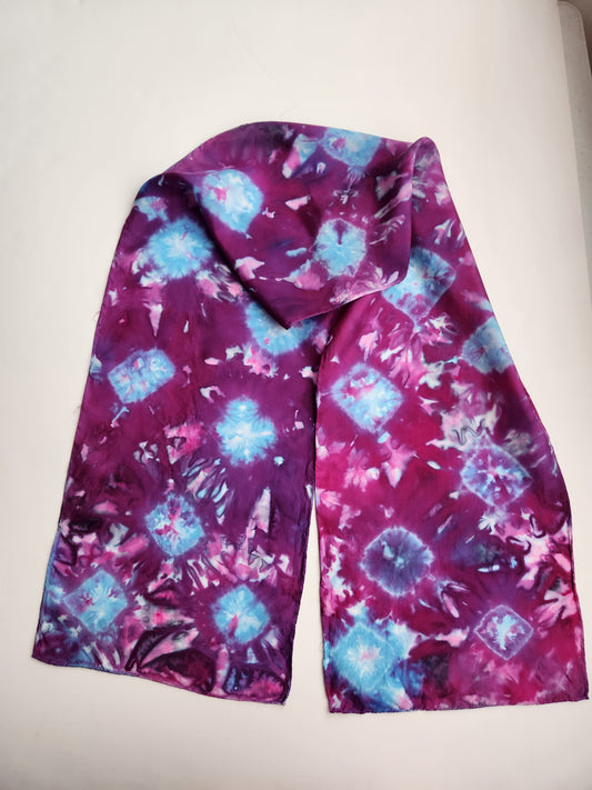 " Abstract Plum and Blue " Hand Dyed Silk Scarf Artist: Crystal Lawrence  11" wide x 60" long Silk Scarf   Hand dyed and painted  Dyed Plum purple and sky blue   Blue pattern can be seen throughout the plum background 