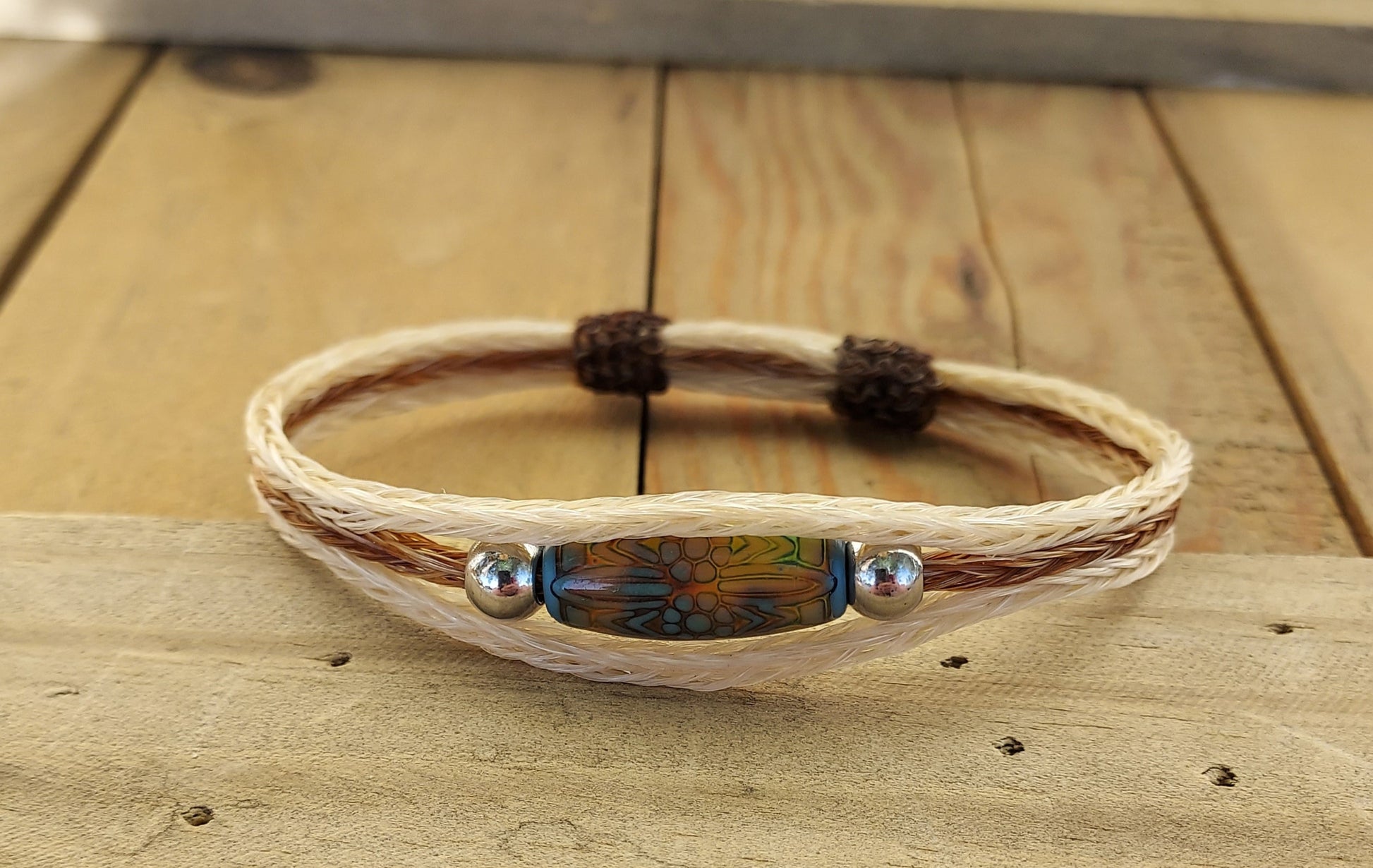 Bracelet with a bead on a wooden surface