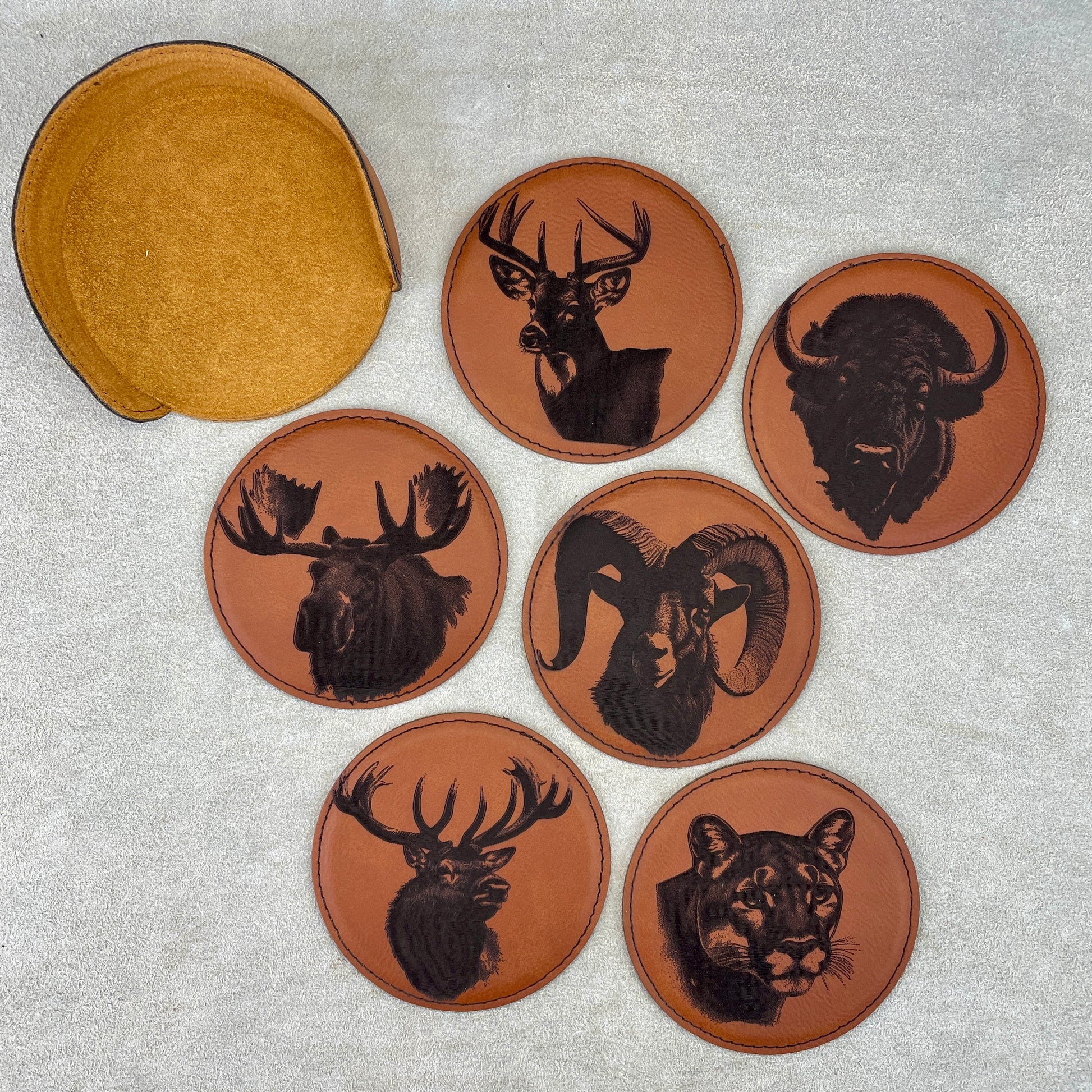 Leatherette Coasters Set of 6 Artist: Marcy Knotwell Protect your furniture in style with these custom leatherette coasters.  These coasters are the perfect way to add a touch of elegance to your home bar or living room. They are made from high-quality leatherette and are laser engraved witht various wildlife. They are also water-resistant and easy to clean, so you can be sure that they will last for years to come.  These coasters make a great gift for any occasion. 