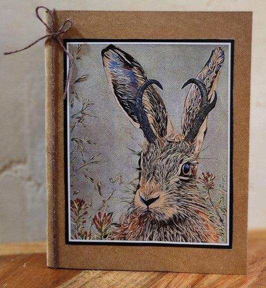 pocket notbook with print of a jackalope from original artwork affixed to the cover
