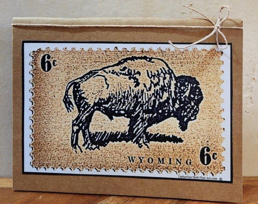 Small pocket notebook with print of original artwork by the artist Vintage style art print of six cent bison stamp affixed to the cover of the notebook