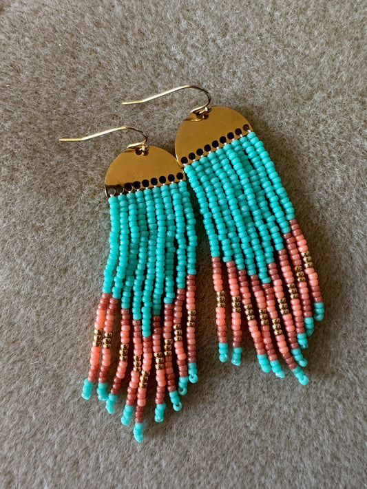 Fringe earings with gold half circle. Turquoise  beads with orange and gold stripe at bottom