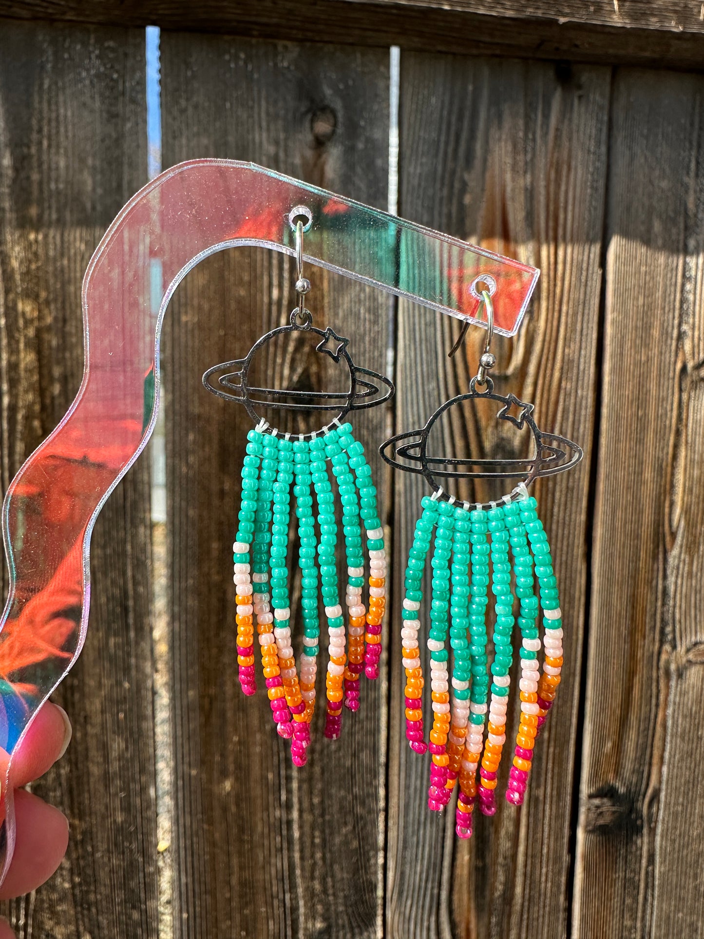 Cosmic Teal Burst Beaded Earrings  These hand beaded fringe earrings are an enchanting addition to your jewelry box  Meticulously crafted  Individually strung  High quality Japanese seed beads   Fitted with stainless steel french ear wires  Suitable for most sensitive ears  2.5" long x 1" wide