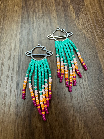 Cosmic Teal Burst Beaded Earrings  These hand beaded fringe earrings are an enchanting addition to your jewelry box  Meticulously crafted  Individually strung  High quality Japanese seed beads   Fitted with stainless steel french ear wires  Suitable for most sensitive ears