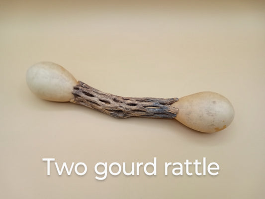 Dried gourd rattle with hollow wooden handel , gourd on each end