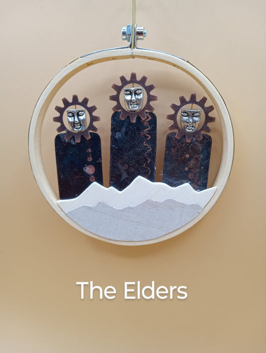 Three figures with differing designs Snow capped mountains in foreground Piece is framed by a curricular hoop