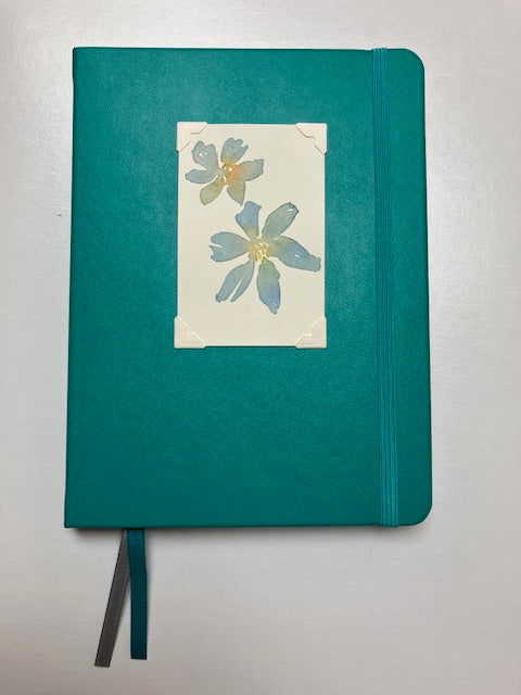 Journal with turquiose cover and original art piece of two blue flowers