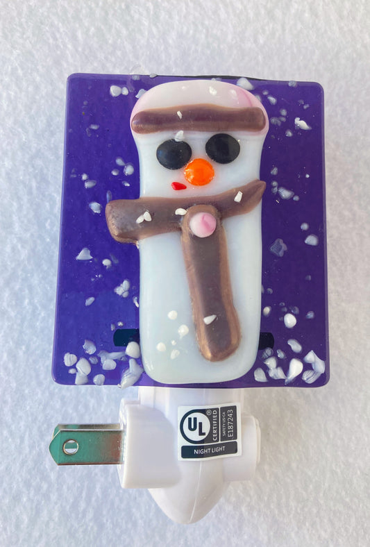 Purple background  Snowman in pink hat with purple brim  Purple scarf with pink button  white snow on bottom of nightlight
