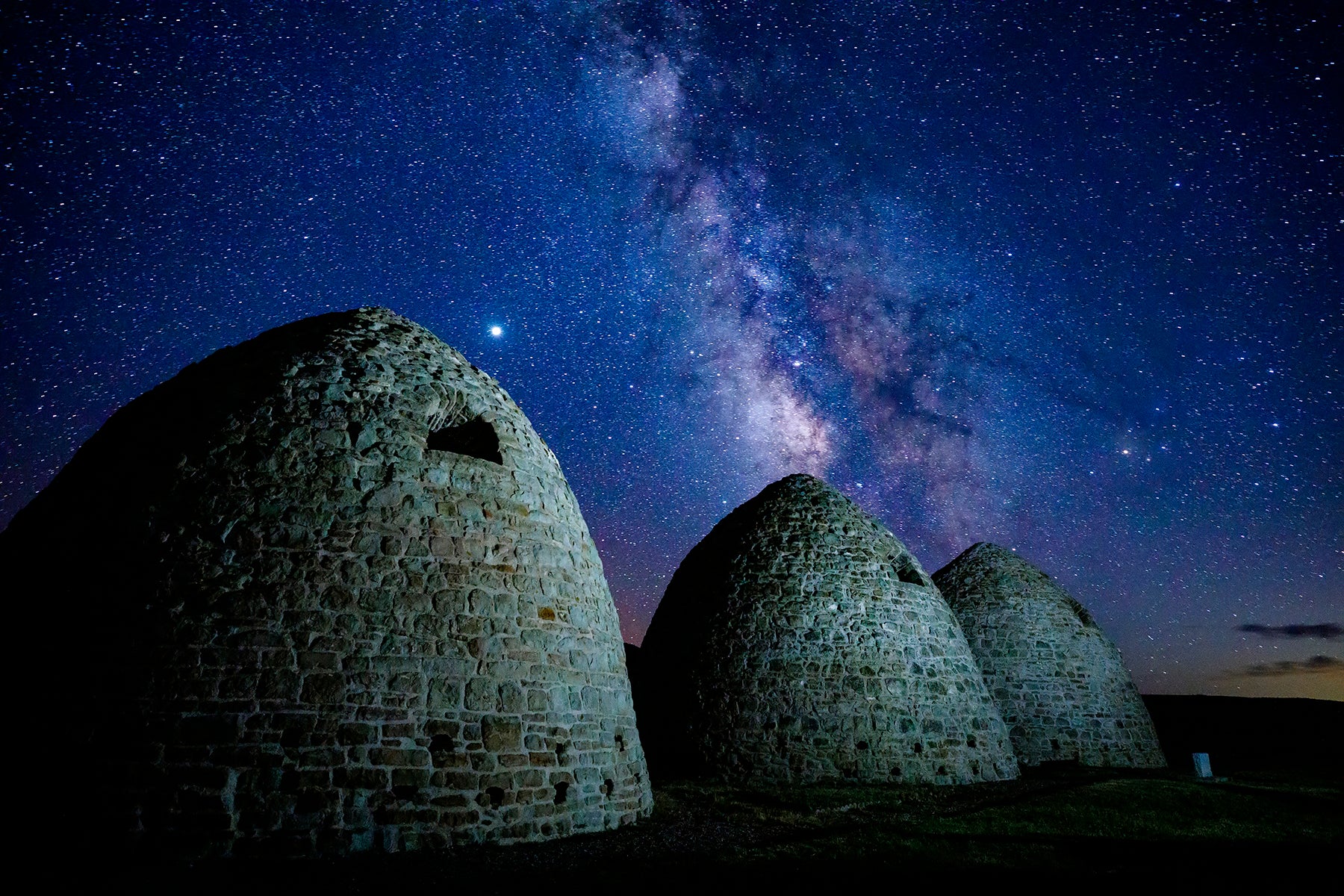 The Milky Way Galaxy fills the night sky above the Piedmont Charcoal Kilns near Evanston Wyoming