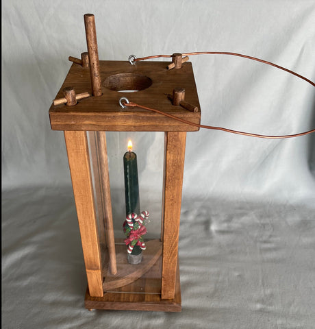 Copied from an 18th century style lantern used during the early days of our country  Commonly found in log cabins, frontier camps, and in the common homes of the time  5.5" long x 15" high x 5.5" wide  Eye-bolts with copper wire attached allowing the lantern to be hung from a hook in the home, the tent, or from a tree.  Wooden lantern not to be used with real candles