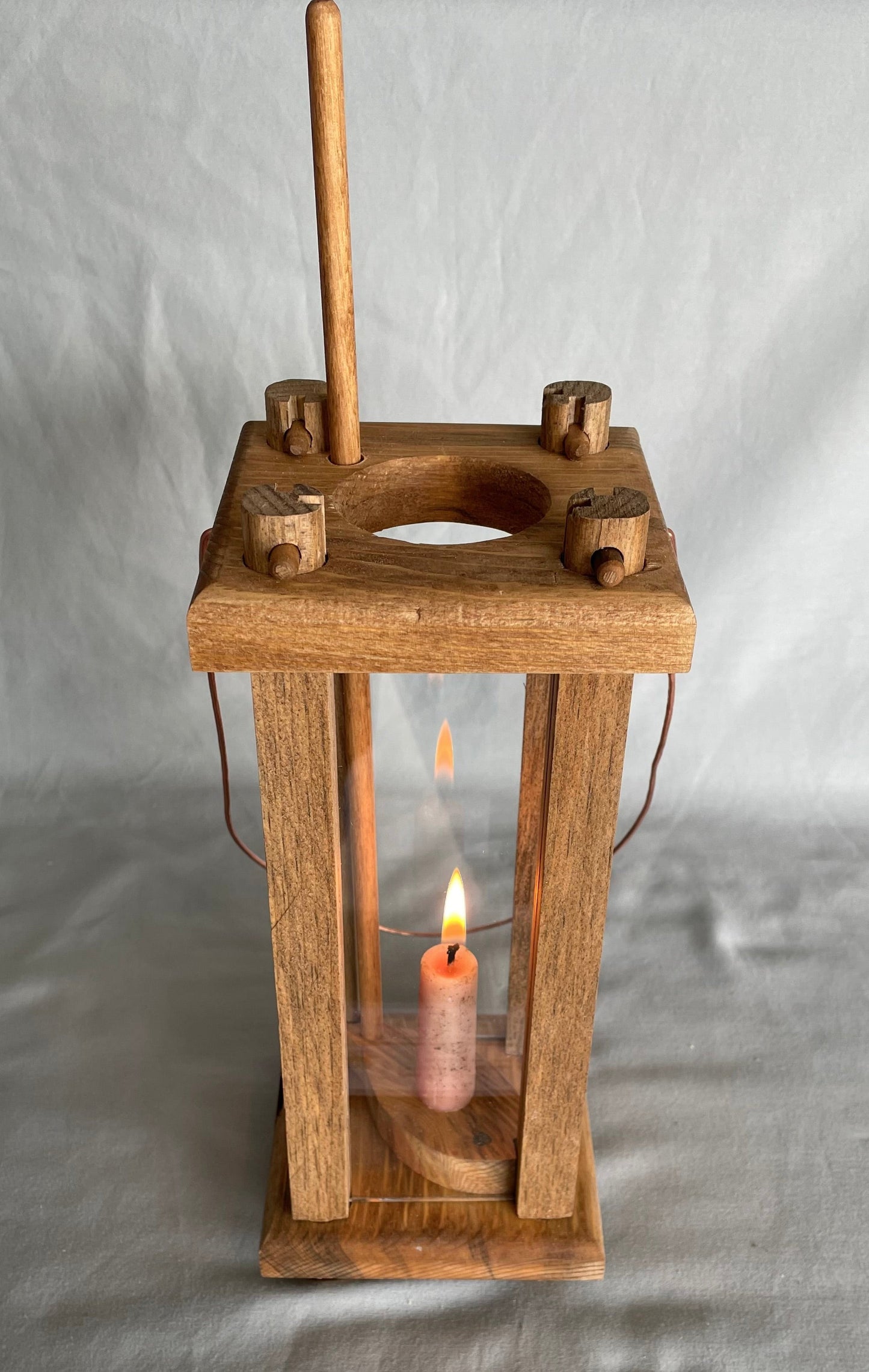 Small copy of a 19th century style lantern used during the early days of our country  Commonly found in log cabins, frontier camps, and in the common homes of the time  4.25" long x 14" high x 4.25" wide  Copper wire attached to the top wooden plate of the lantern allowing the lantern to be hung from a hook in the home, the tent, or from a tree  Will bring nice ambiance to a home or for those times when the power is out. Battery candles recoomended to prevent fire hazard