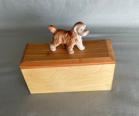 Super sweet Vintage, ceramic Cocker Spaniel mounted on a wood gift box. This box has a Cedar lid, with an Aspen box. The matching colors of the spaniel and wood make for a nice center piece on the desk or next to the bed. This gift box can hold keepsakes and treasures from a loved one, while the beloved Cocker Spaniel watches over them.