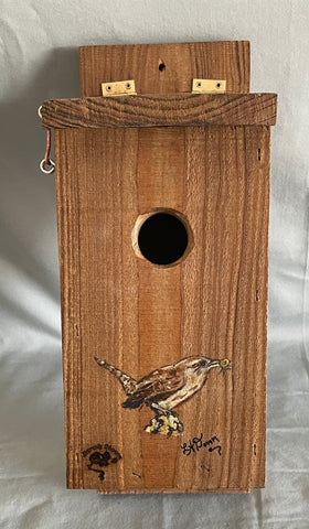 All cedar box, roof and floor with a cute wren painted on front  Hook and eye bolt closure in the roof allows for easy access to clean the box  Two holes drilled into the back board for screws when hanging the box  Wren nesting boxes will also house Chickadees and Finches  14" tall x 5" wide x 6 1/2" long
