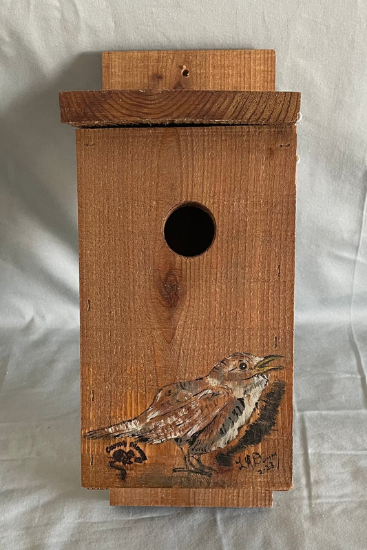 All cedar box, roof and floor with a large wren painted on the front  Hook and eye bolt closure in the roof allows for easy access to clean the box  Two holes drilled into the back board for screws when hanging the box  Wren nesting boxes will also house Chickadees and Finches  14" tall x 5" wide x 6 1/2" long