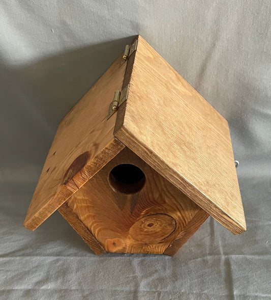 Pine bird house with a cedar wood floor  Hook and eye bolt closure in the roof allows for easy access to clean the box  Hole in the back of the house allows to hang the bird house on a screw in a wall or on a fence  Wren nesting boxes will also house Chickadees and Finches  7" tall x 7 1/2" wide x 6 5/8" long