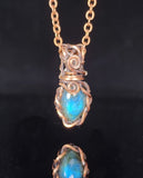 Labradorite in hand woven oxidized copper wire  .98" long x .43" wide  Copper chain necklace with lobster clasp  Care instructions and cleaning cloth provided  Small pendant that can be used for everyday wear