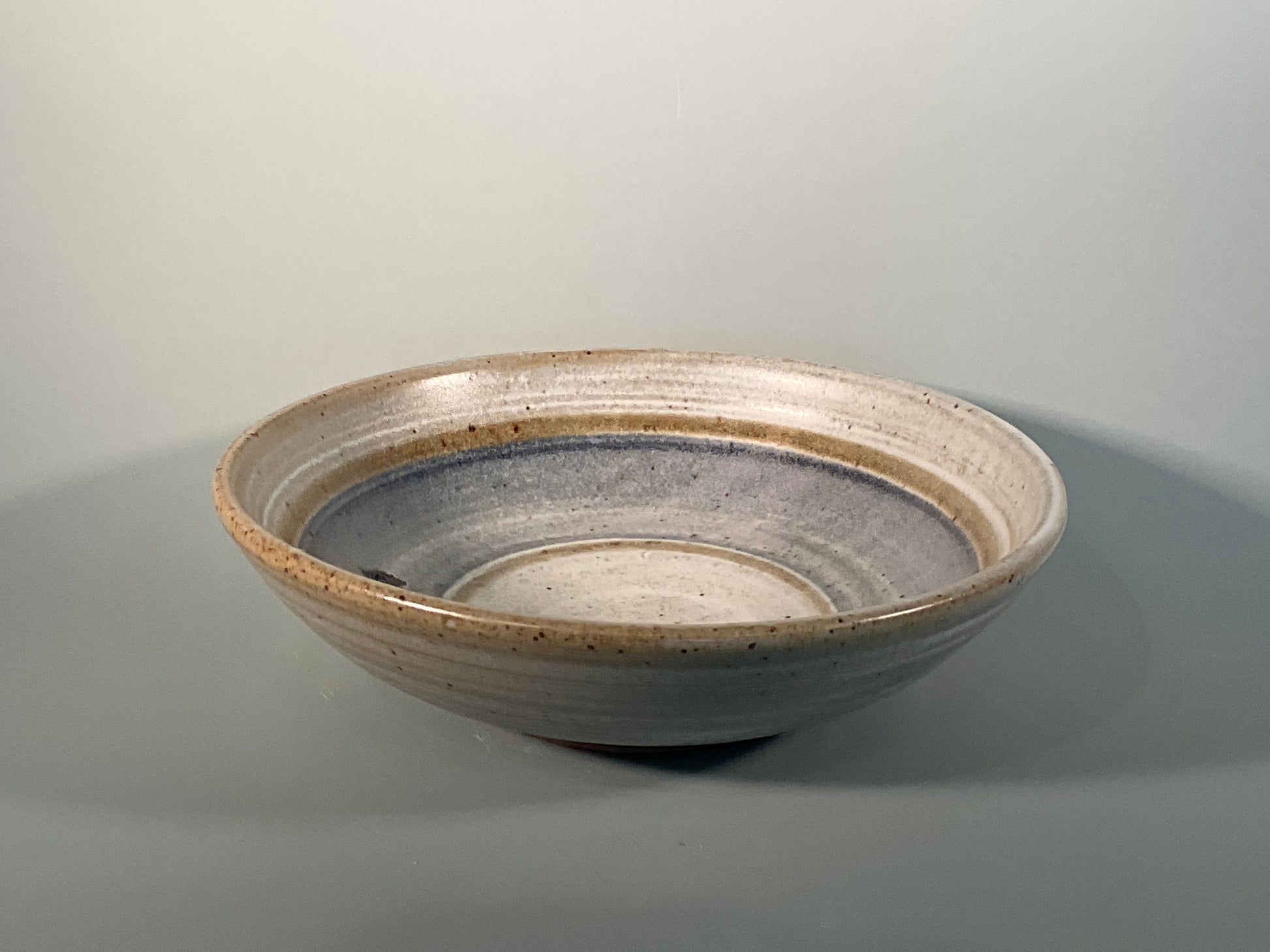 Gray glazed with large blue stripe ringed by small gray stripes  Great for food or as a unique center table decoration  8" Long  x 8" Wide x 2" Tall