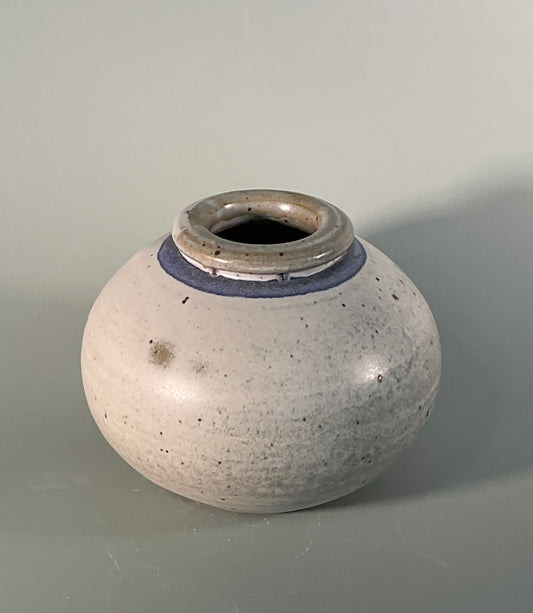Gray glaze with blue stripe near rim  3.5" Long  x 3.5" Wide x 5" Tall  Beautiful hand thrown stoneware vase  Dishwasher safe  Great for kitchen storage