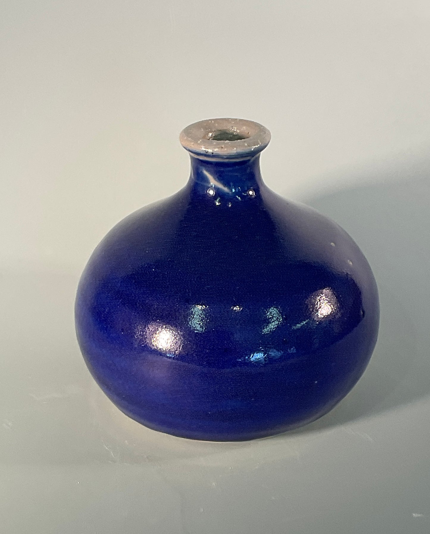 Solid blue color  Nice size round vase With blue glaze and small flair at rim  5" Long  x 5" Wide x 4" Tall  Beautiful hand thrown stoneware vase  Dishwasher safe