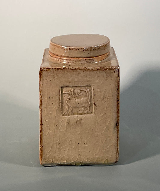 Muffy Moore: Ceramic Potter  Hand thrown stoneware  Square shape with round lid and dog  Chun glaze