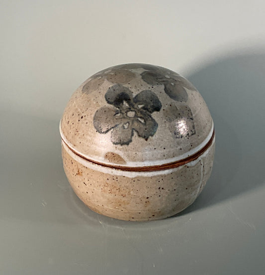 Round covered box with gray glaze  Blue and gray flowers on lid of box  4' long 4' wide 4' high