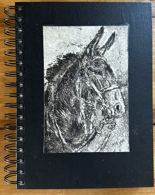 Mule looking to the right on a spiral bound note book