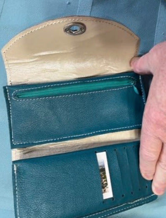 teal leather interior. card slot folds out to access checkbook pocket