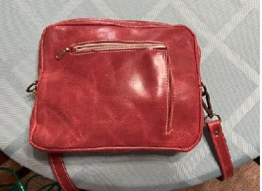 Leather Cross body purse  Long adjustable leather shoulder strap  Large pocket to carry larger items, such as wallets, sunglasses or snacks  External pocket allows easy access to smaller items such as keys  Both pockets are zippered giving the items security  Pale Red / Pink leather stitched with white thread  Use as an everyday purse, or perfect for a night on the town  10" long x 8" high x 1 1/2" wide