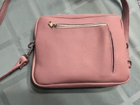 Leather Cross body purse  Long adjustable leather shoulder strap  Large pocket to carry larger items, such as wallets, sunglasses or snacks  External pocket allows easy access to smaller items such as keys  Both pockets are zippered giving the items security  Supple Light Mauve Purple leather stitched with white thread  Use as an everyday purse, or perfect for a night on the town  10" long x 8" high x 1 1/2" wide