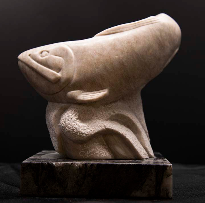 " Swish " Alabaster Fish Sculpture Sculpture Artist: Jerry Wood  Carved from Colorado Alabaster   Shapes and textures from the Colorado Alabaster   Alabaster Trout with Textured tail and smooth finish on body  7" long x 8" wide x 4" high   Comes with a base for display  Title, date and artist signature carved into lower edge of the piece  This very unique and one of a kind piece will be the center of attention in any collection   Please note item is hand sculpted by the artist
