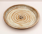 Hand Thrown Stoneware Pottery  Brown and Pearl glaze harmonizes the interior texture of the serving tray  Cowboy riding a bucking bronc stands out in the center of the tray  Braided rope texture along the rim of the tray is added beauty  12" across x 1 1/2" high  Bring the western flare to your dinner table with this one of a kind serving dish