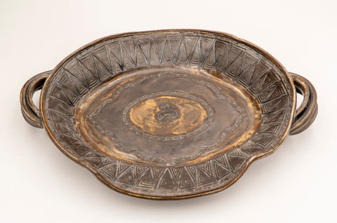 Hand Thrown Stoneware Pottery  Brown and Gold glaze  Cowboy riding a bucking bronc stands out in the center of the platter  Design looks like a rodeo belt buckle  14" long x 12" wide  x 2 1/2" high  Bring the western flare to your dinner table with this one of a kind serving platter
